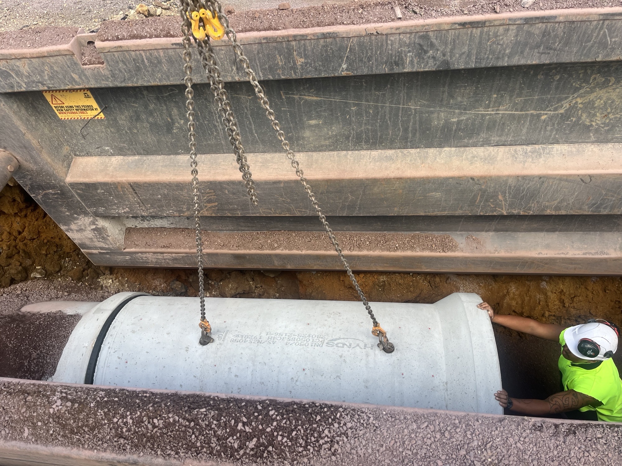 Pipe lowered into cavity below road surface